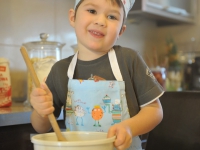 small boy chef baking cake