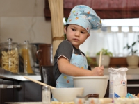 small chef boy baking cake
